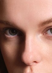 Woman with blonde wavey hair looking into the camera