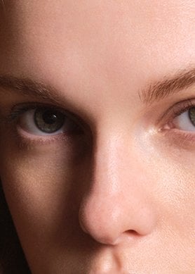 Woman with blonde wavey hair looking into the camera