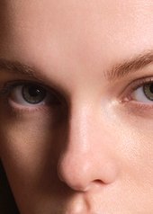 Woman with blonde wavey hair looking into the camera