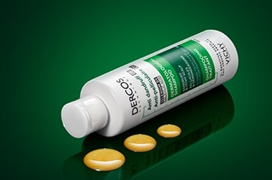 Dercos for Normal to Oily Hair laying on its side alongside 3 neat droplets mobile