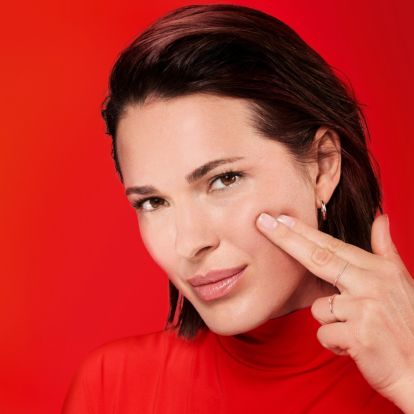 woman lightly pressing two fingers into her cheek_mobile