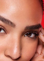 Close up of a woman resting her fingers by her eyes