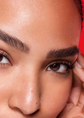 Close up of a woman resting her fingers by her eyes