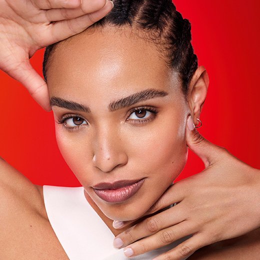 close up of a woman resting her hands on her face