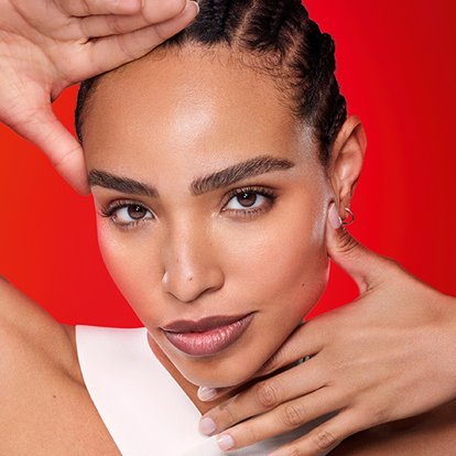 close up of a woman resting her hands on her face