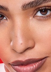 close up of a woman resting her hands on her face